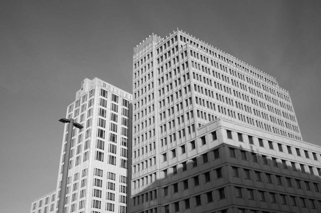 Stylish black and white image of modern buildings in Berlin showcasing urban architecture from a low angle.