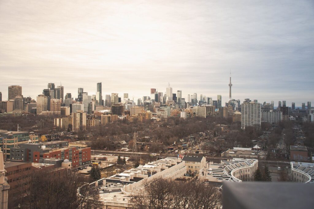 A stunning view of Toronto's skyline featuring the iconic CN Tower under an overcast sky.