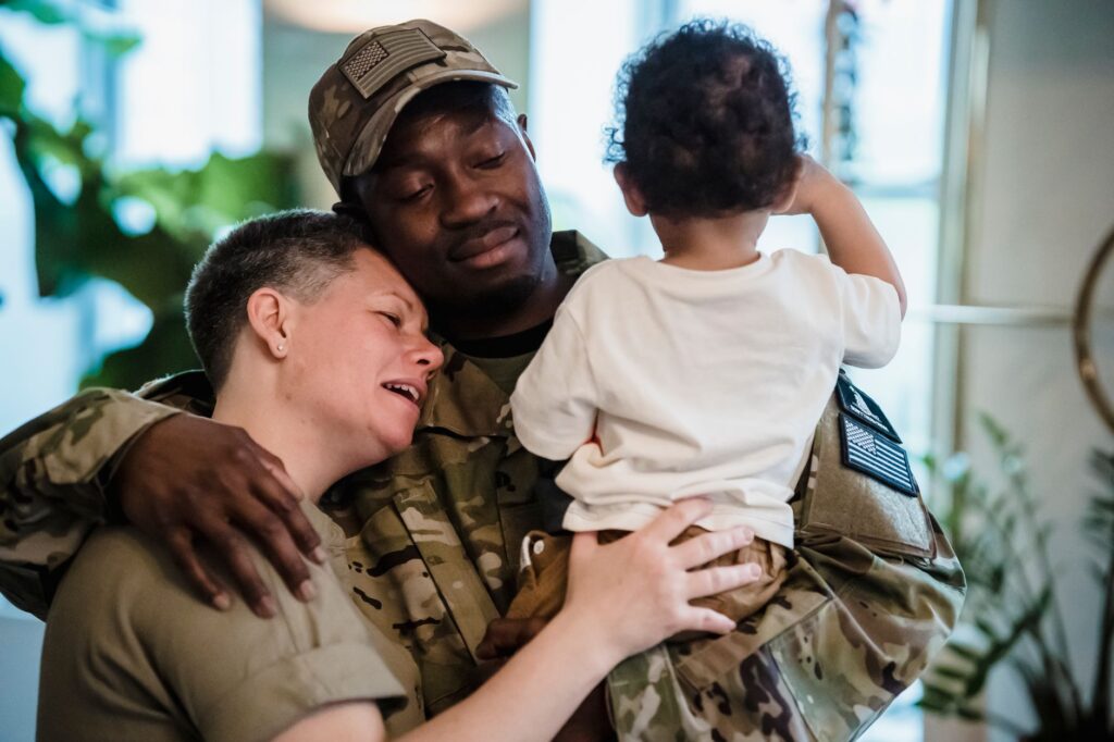 Emotional reunion between soldier and family, symbolizing love and togetherness.