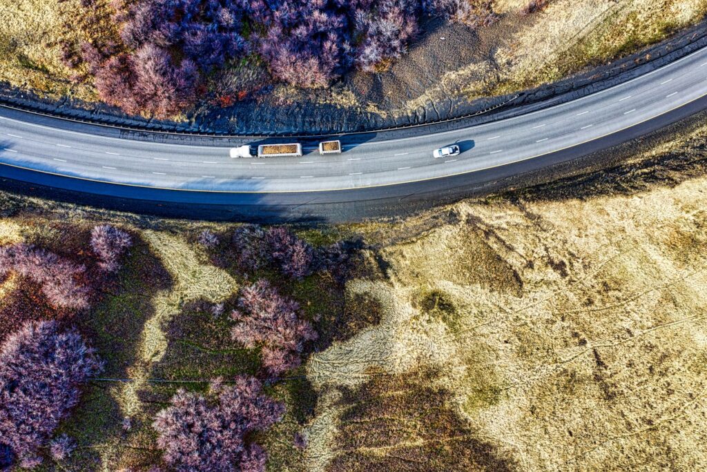 Drone shot capturing vehicles on a curved highway in Huntington, Oregon.